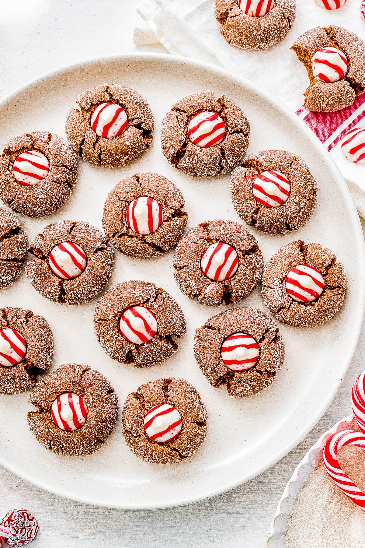 Chocolate Peppermint Kiss Cookies on a white plate. Chocolate Peppermint Kiss Cookies on a white plate.