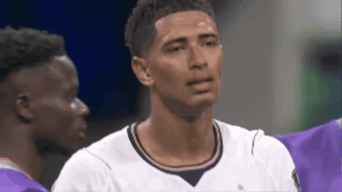 a man in a white shirt with a star on the collar is crying