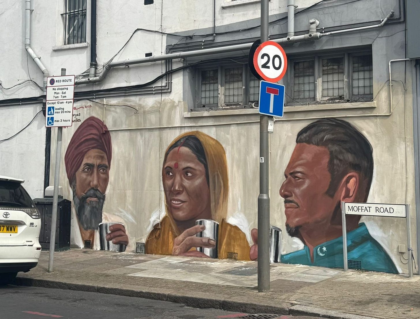 May be an image of 3 people, street and text