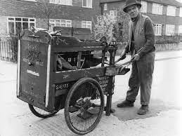 black and white photo of a 1950s sidewalk peddler with a pushcart. black and white photo of a 1950s sidewalk peddler with a pushcart.