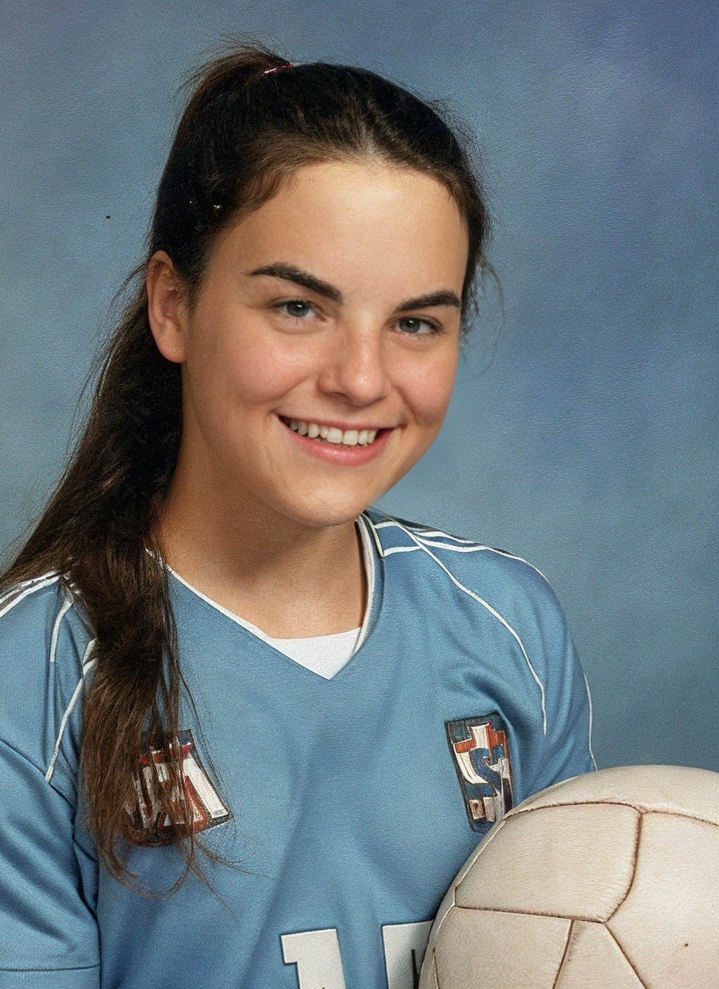 An AI-generated picture of myself created by Epik, of a teenage me as a girl in a soccer uniform.