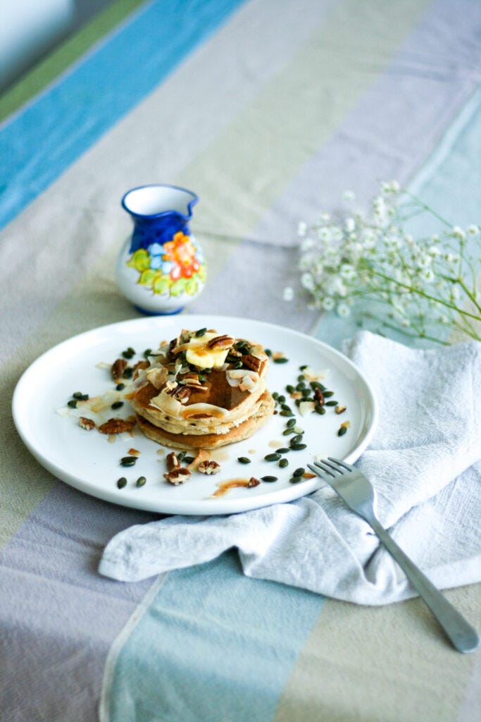 Fluffy oat pancakes with butter and maple syrup