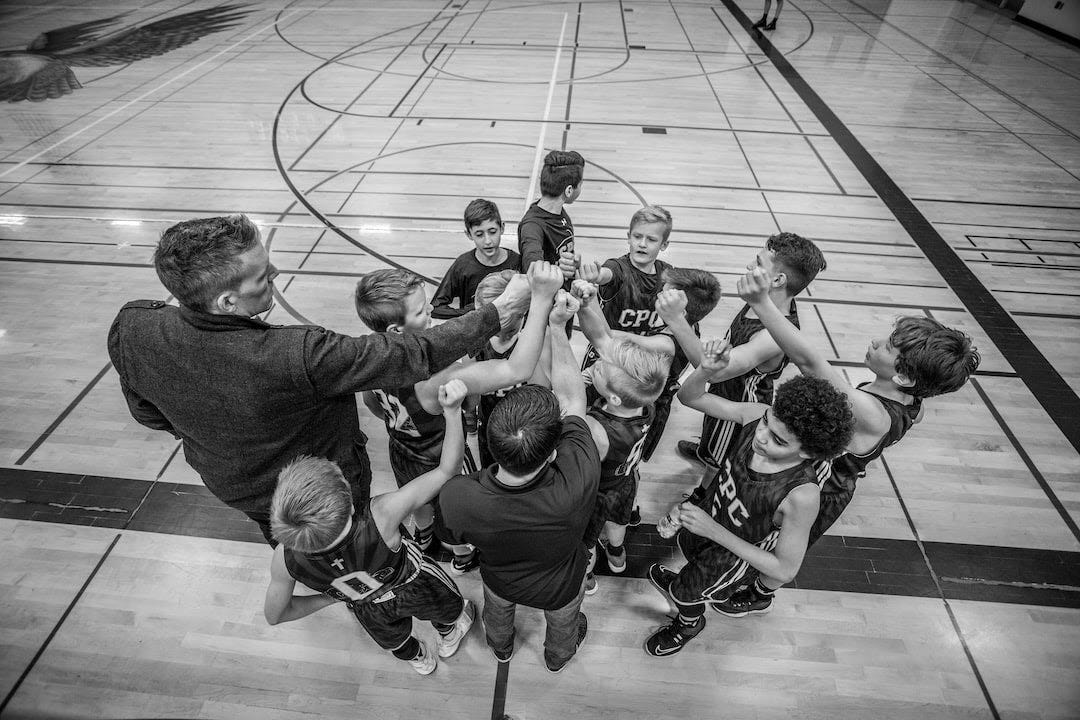 grayscale photography of boys raising hand grayscale photography of boys raising hand