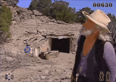 a man in a cowboy hat stands in front of a building with the number 00630 on the screen