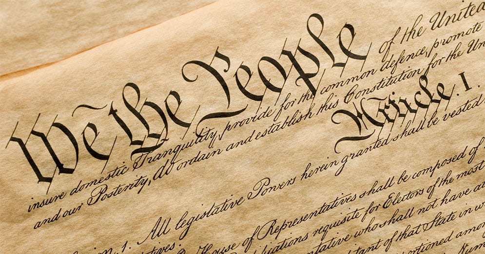 Top of the United States Constitution document showing the words "We the People" Top of the United States Constitution document showing the words "We the People"