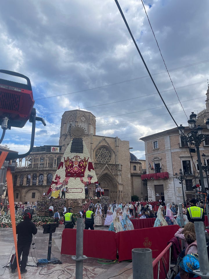 The construction of a Virgen Mary made of flowers, before and after