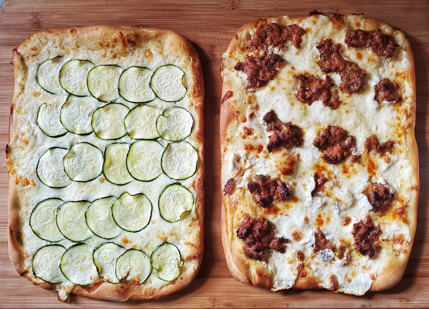 pizza night Cleveland cooking. the pizza to the left is a zucchini pizza and the pizza to the right is a sausage pizza
