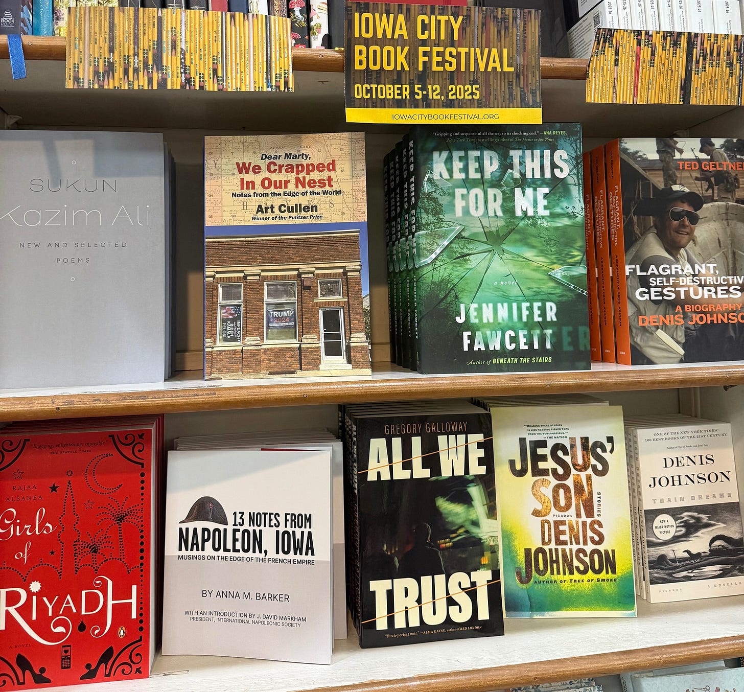 May be an image of ‎newsstand and ‎text that says '‎IOWA CITY BOOK FESTIVAL OCTOBER 5-12, 2025 ICHACITEJJKFEST/AHC re: Martyi We Cra Crapped חלי Dur nOurNest Nesti nypc SUKUN Kazim Ali HEWANEREIFCTS ANU HE" FETE: POLAS Cullen Matk 賛気牛アミ лaw عبطة KEEPTHIS EEP THIS FOR ME TEDGELTN GELTNE FLAGRANT, SELF-DESTRUCTIV GESTURES JENNIFER FAWCETT raLALAZ TAES DENIS JOHNSO Sirls 13 NOTES FROM NAPOLEON. FTHE DENIS JOHNSON TRAINDRELNE TRALM θyΑ4ΝAbl BARKER ALLWE JESUS SON DENIS JOHNSON TRUST atHaner TAKE cEeT S-P RIYADH צתה גפת‎'‎‎