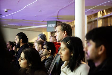 Images of artists working with computers and projectors in an art gallery