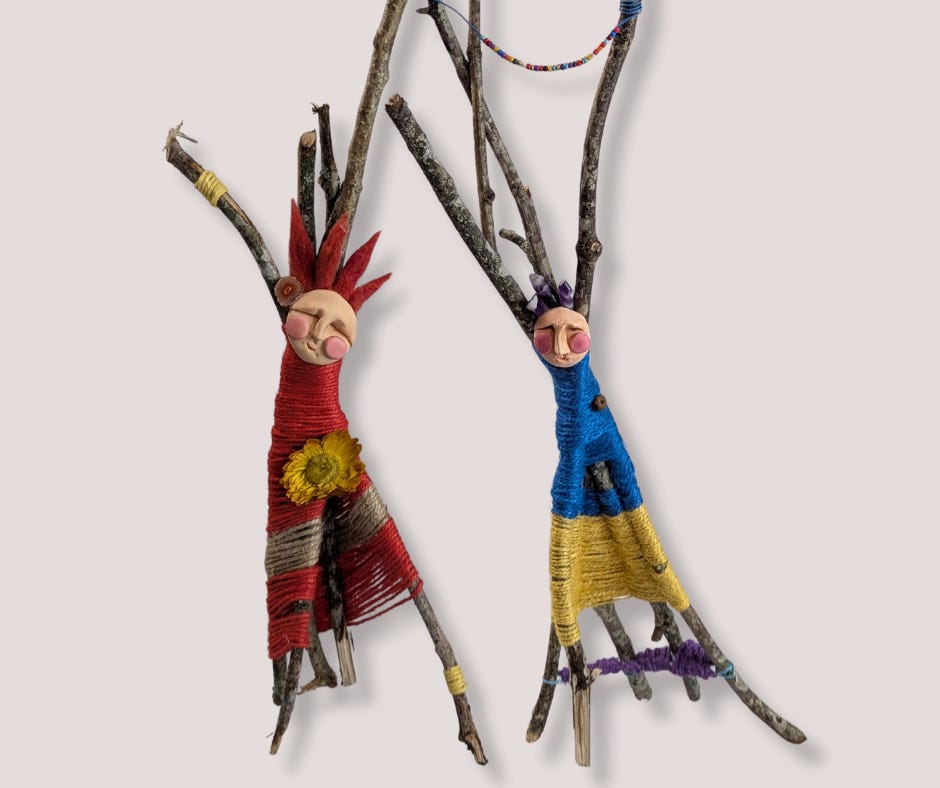 two stick dolls with quirky clay faces and bodies wrapped with twine around the sticks