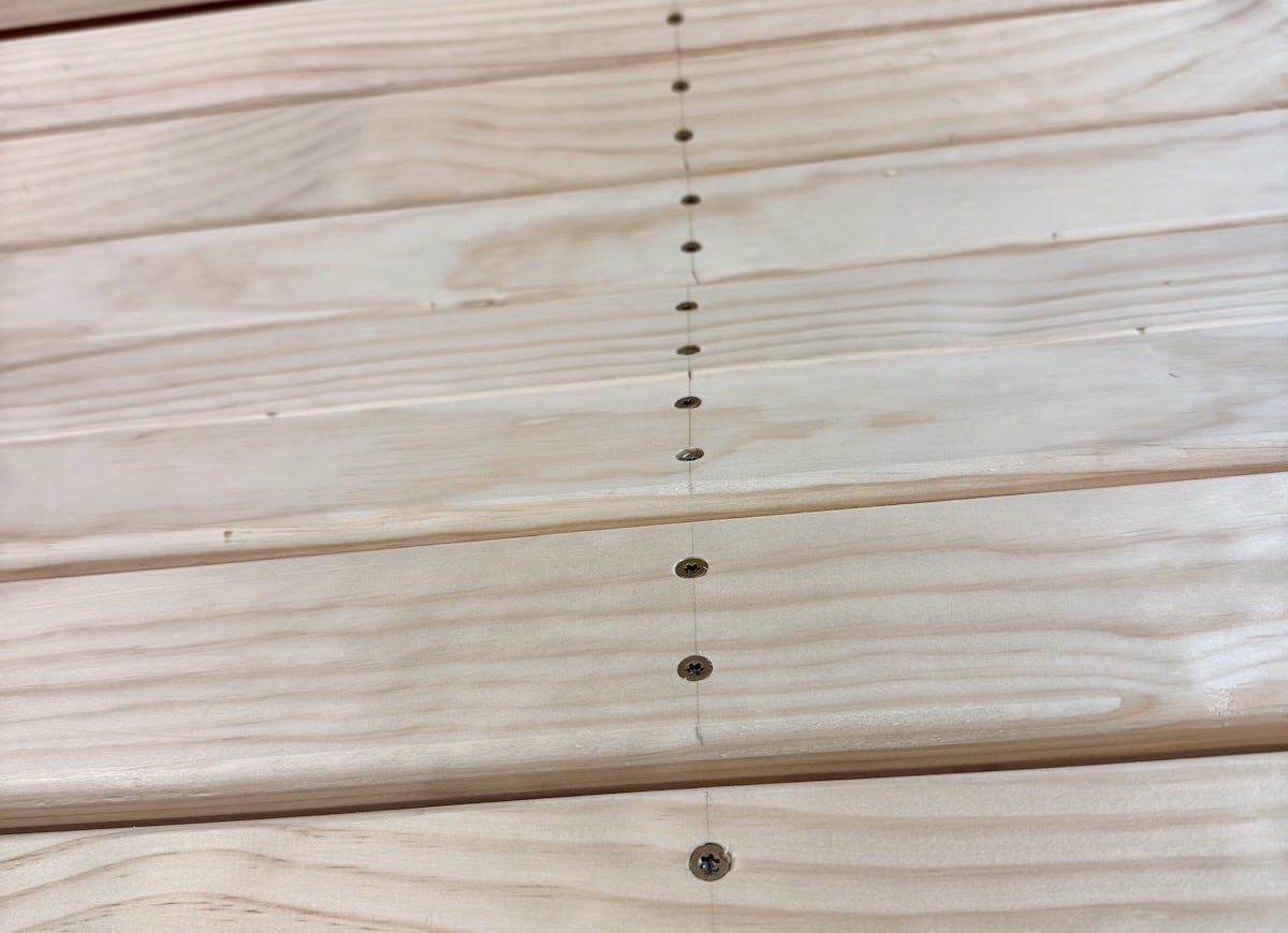 Close-up shot of porch swing seat screws all lined up. Close-up shot of porch swing seat screws all lined up.