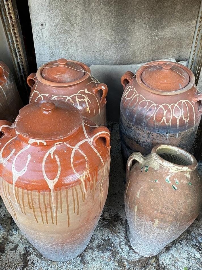 A group of clay pots
AI-generated content may be incorrect.