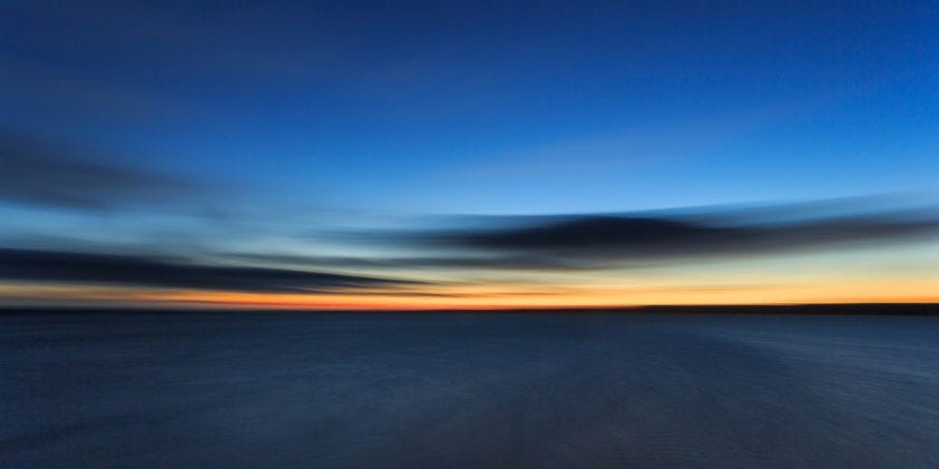 A beautiful colorful Arctic sunset is above the Arctic ocean. Due to extended exposure, the sea became soft. (copyright Anette Mossbacher)