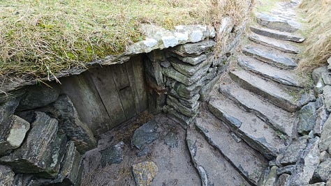 Iron age house at Bosta, and bell