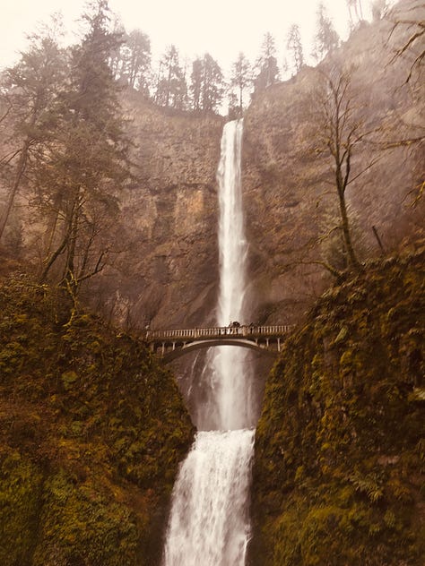 Multnomah falls, Kacey waving from the river, a paddle