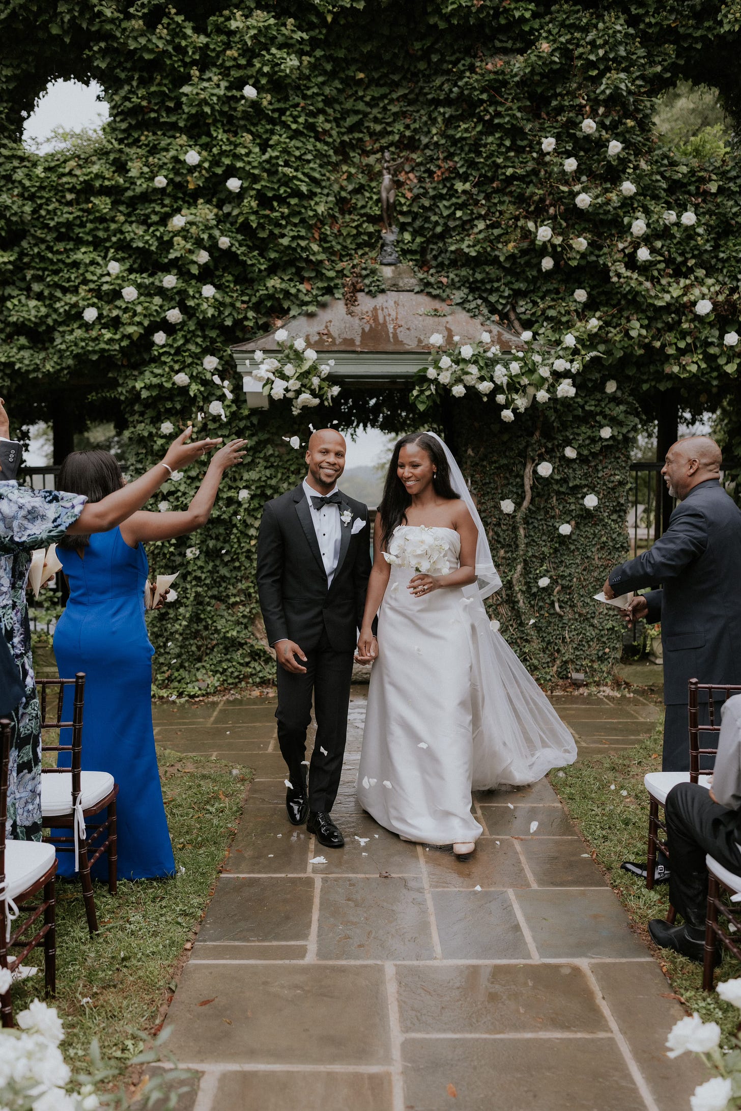 Lisette and her husband walk down the aisle following their wedding