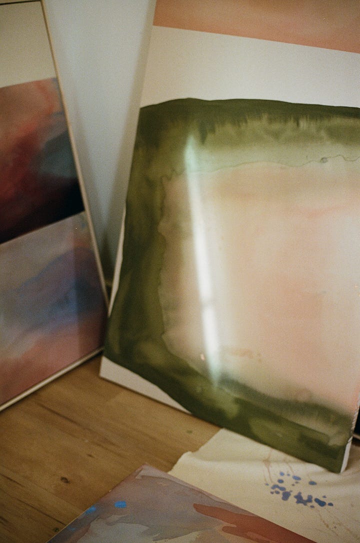 cinder blocks prop up a raw canvas for abstract artist Brenna Hodges; an original painting of green and peach by abstract artist Brenna Hodges