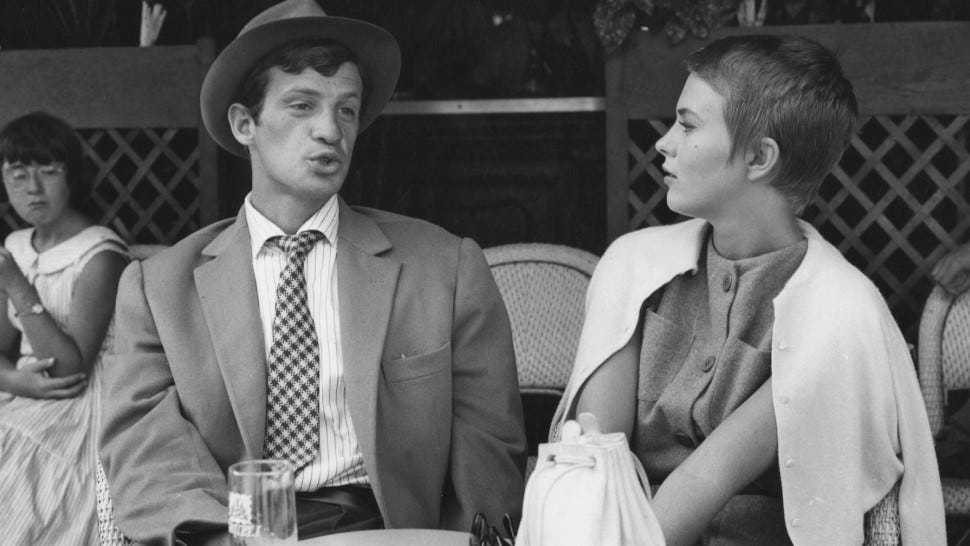 Jean-Paul Belmondo and Jean Seberg on a table outside a cafe in Breathless Jean-Paul Belmondo and Jean Seberg on a table outside a cafe in Breathless