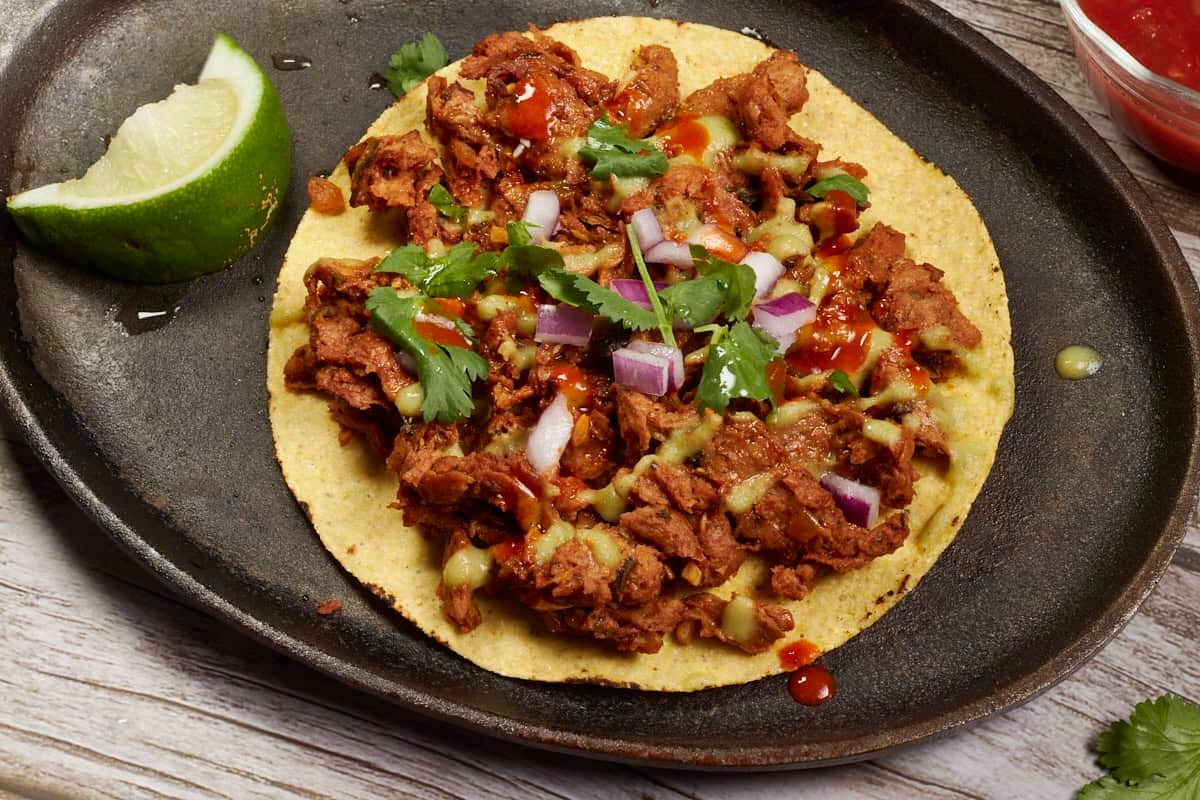 corn tortilla topped with vegan carne asada