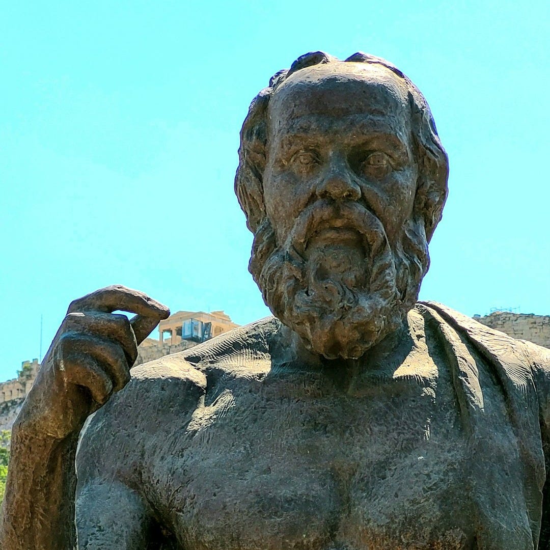 a statue of a man holding a book a statue of a man holding a book