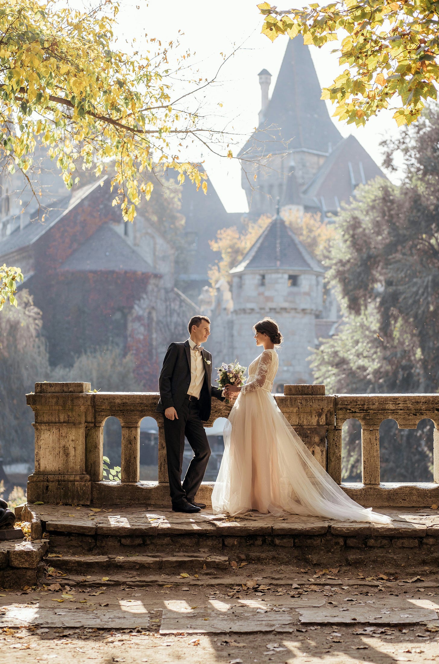 a bride and groom against a leafy background