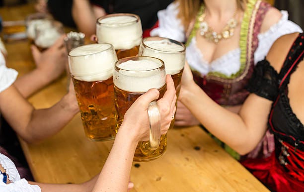 women enjoying beer at oktoberfest - oktoberfest stock pictures, royalty-free photos & images