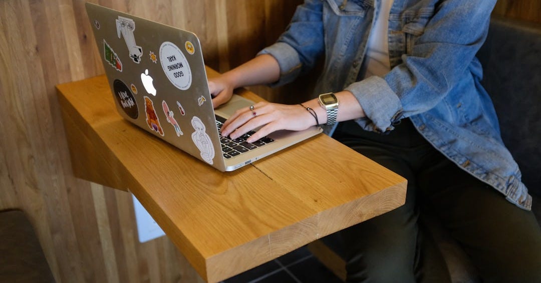 woman sitting and using MacBook