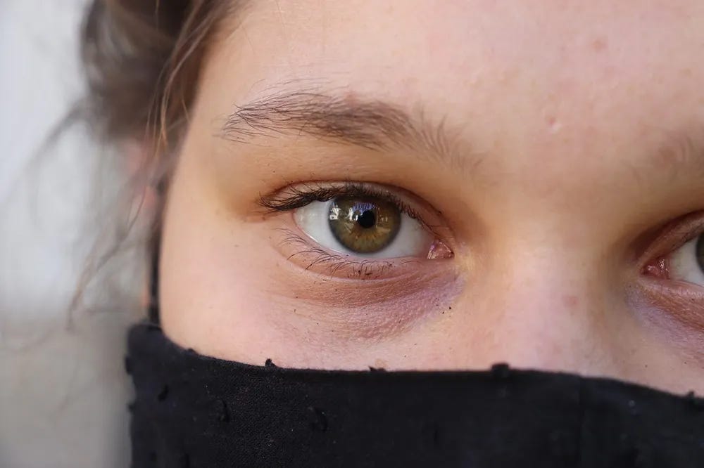 woman with  a scarf wrapped around her lower face