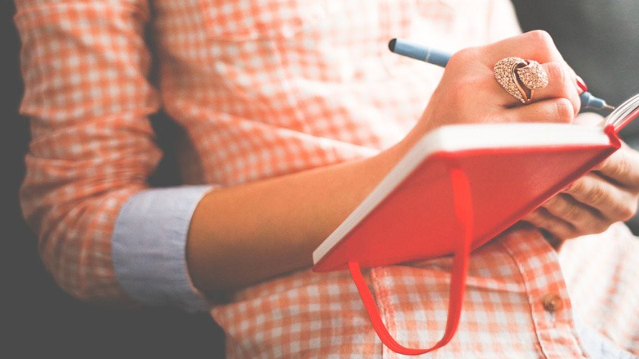 woman writing in journal