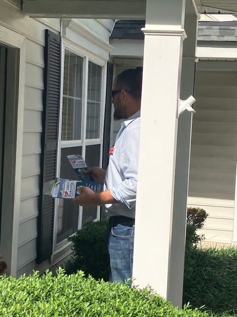 Oictures of John Slokovitz with his wfe and kids and knocking on doors