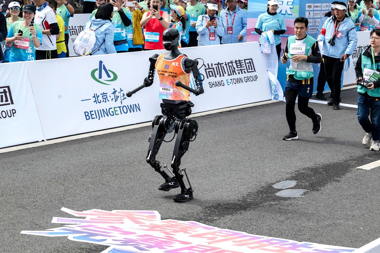BEIJING CHINA  APRIL 19 A Humanoid robot called Tiangong runs after the finish line in the Beijing ETown Humanoid Robot...