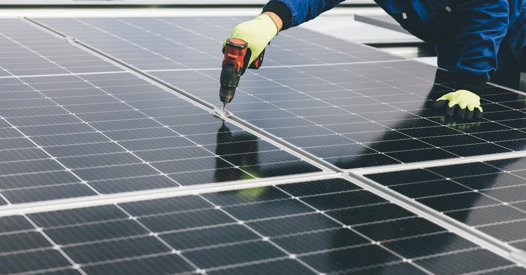 a person working on a solar panel a person working on a solar panel