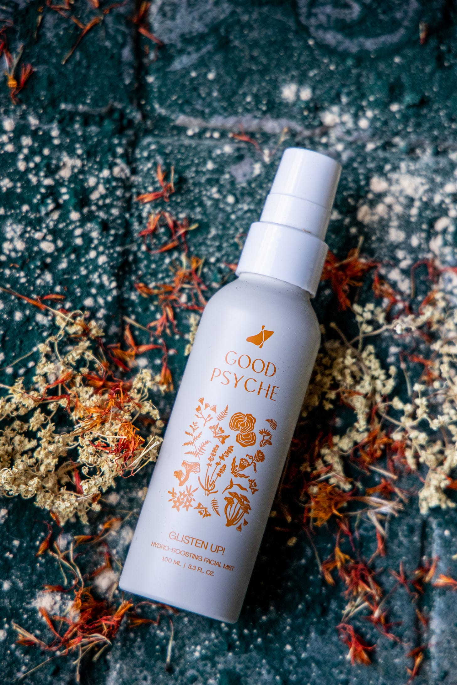 "Good Psyche" Glisten Up! Hydro-Boosting Facial Mist placed on a natural stone-like surface surrounded by moss. "Good Psyche" Glisten Up! Hydro-Boosting Facial Mist placed on a natural stone-like surface surrounded by moss.