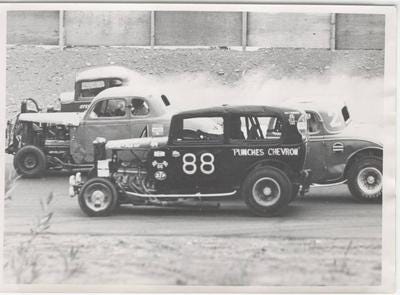 Cars race for the lead at the race track in Anchorage, Alaska.
