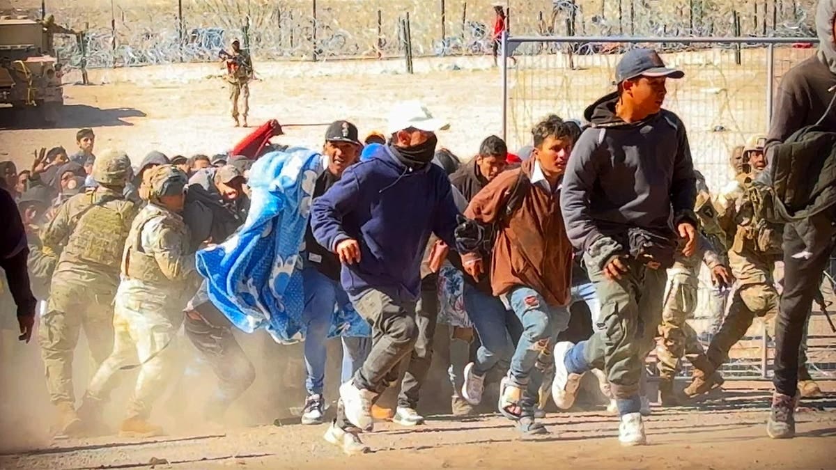 Migrants storm the gate at the border in El Paso Migrants storm the gate at the border in El Paso