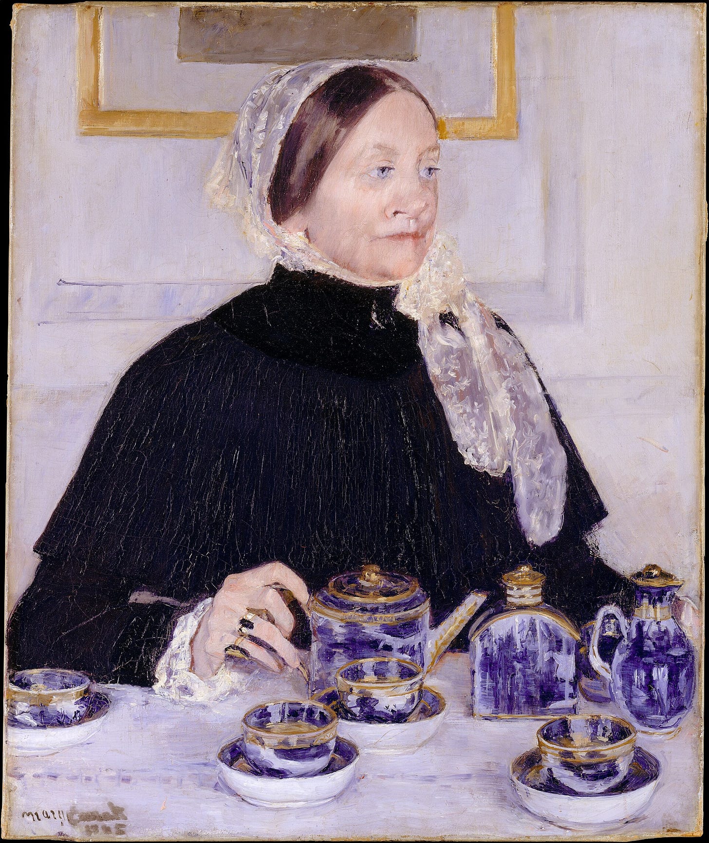 An older woman in a black dress and white lace cap sits upright behind a tea table, her hand resting on a blue and gold porcelain teapot.