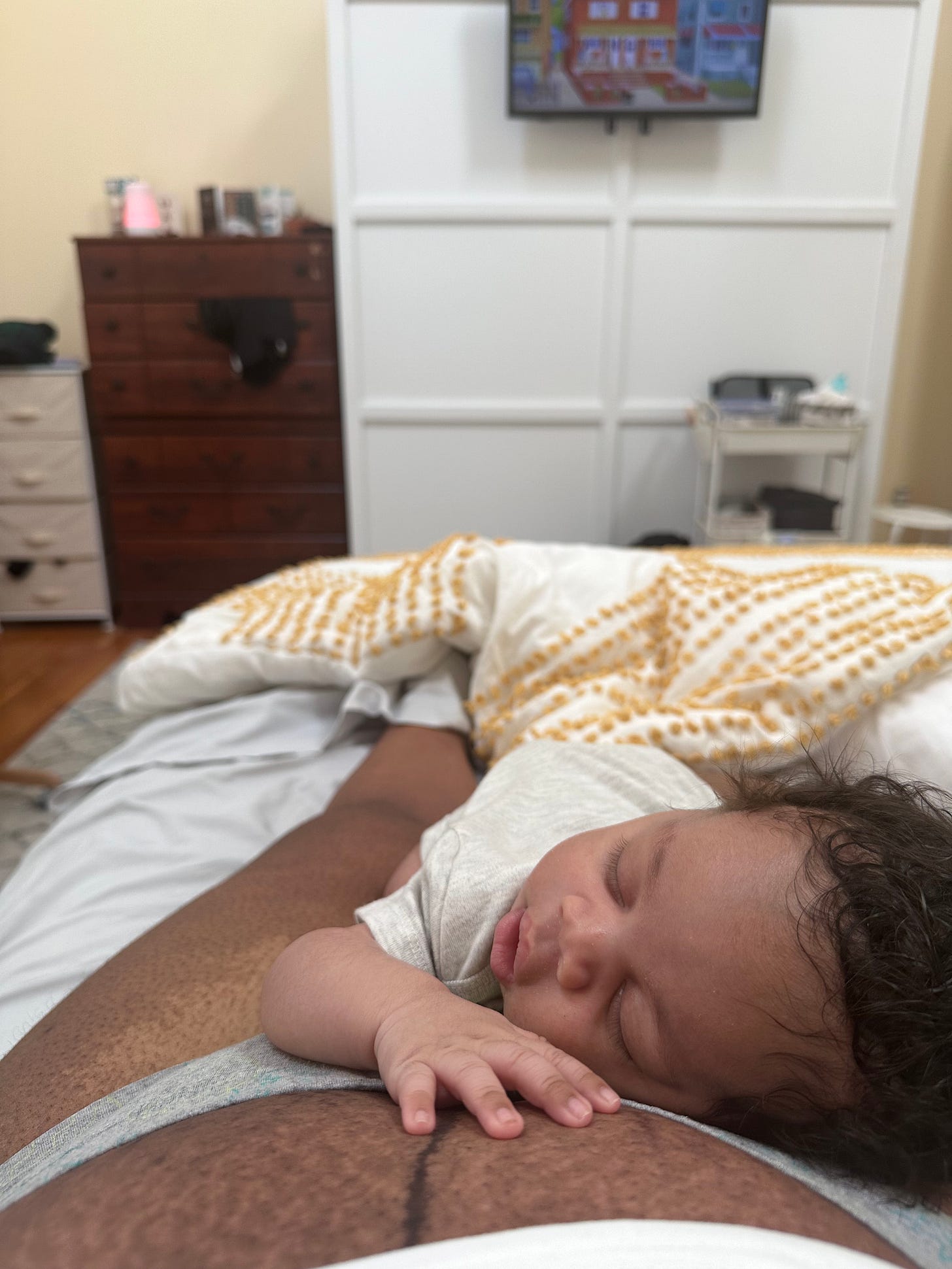 photo of a newborn baby laying on their mother's postpartum stomach