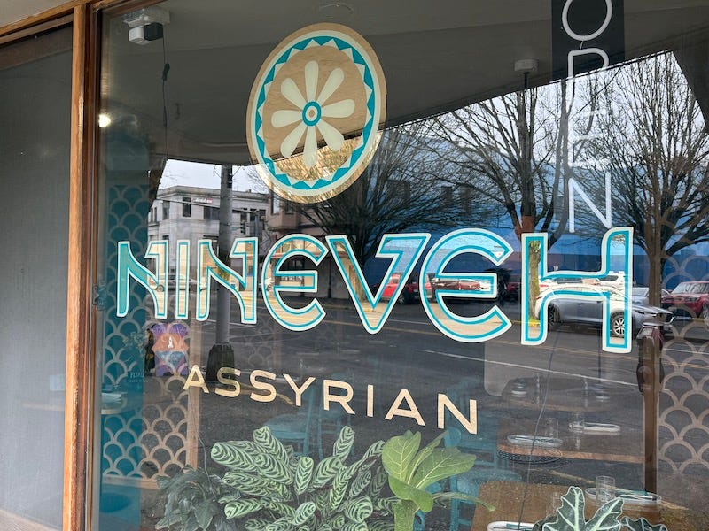 Gold leaf lettering on the front window of Assyrian restaurant Nineveh