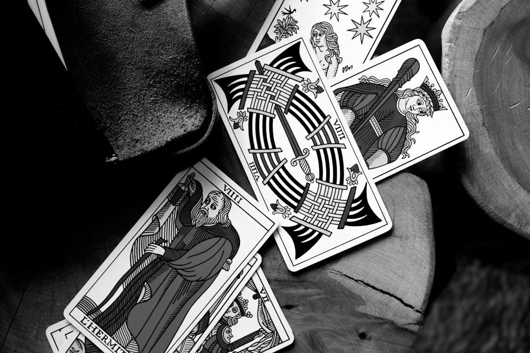 four playing cards sitting on top of a wooden table
