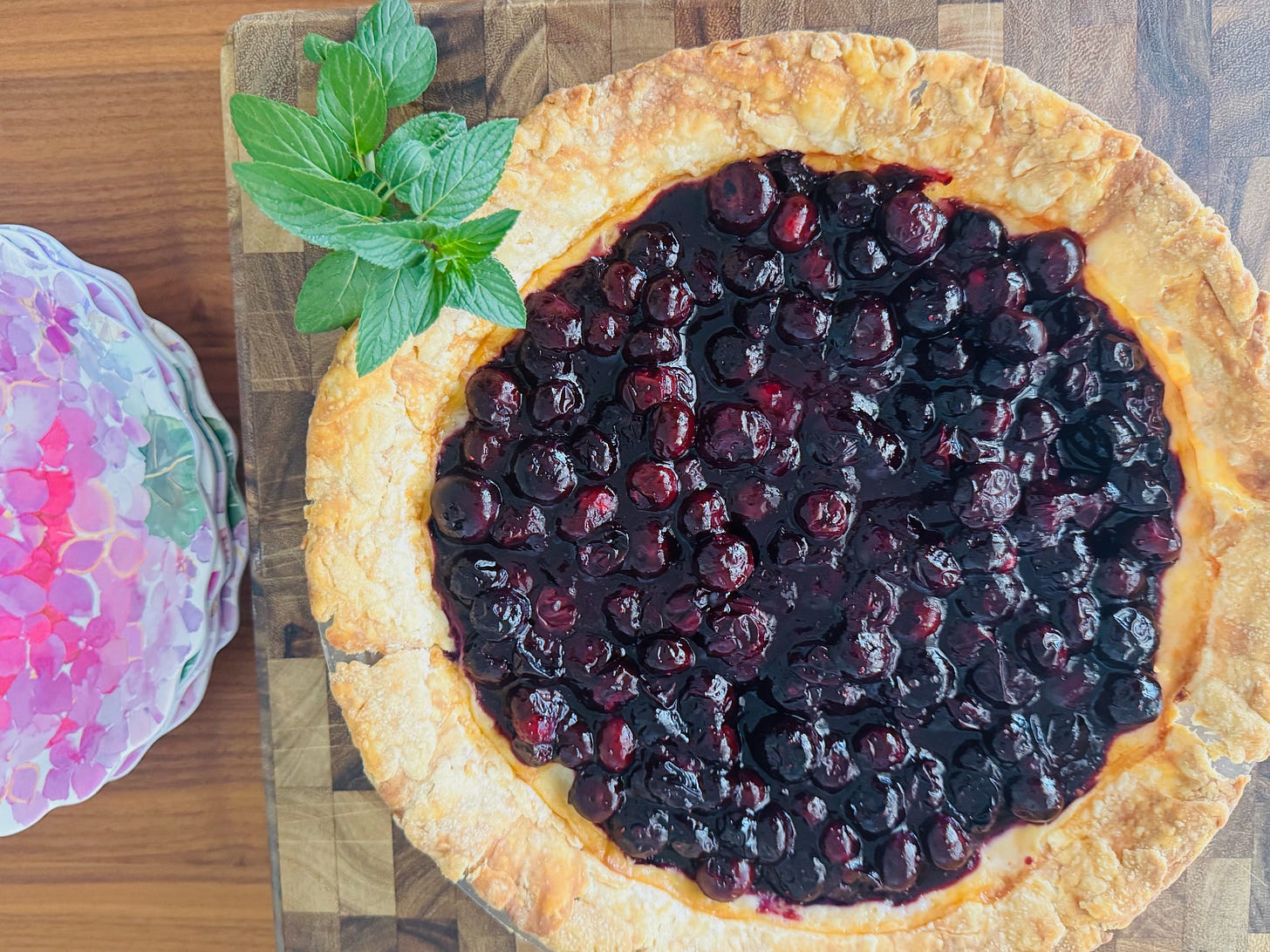 Helen Carne's Old Fashion cream pie with California blueberry compote with plates ready for serving pie. Helen Carne's Old Fashion cream pie with California blueberry compote with plates ready for serving pie.