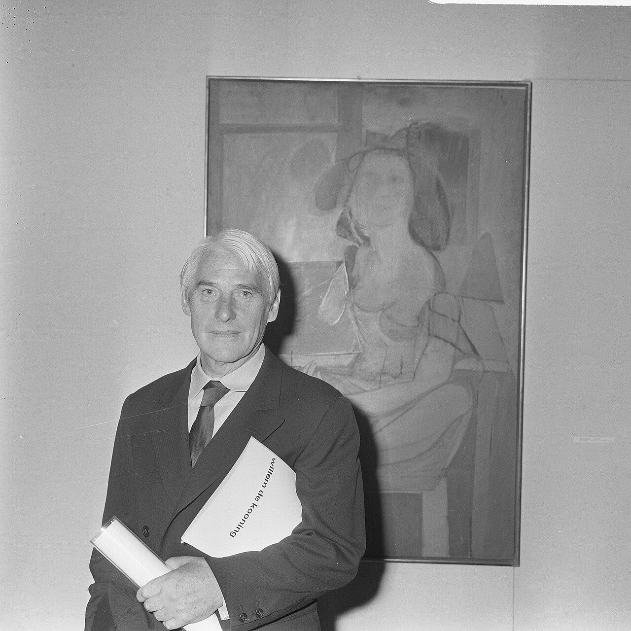 Willem de Kooning posing in front of one of his paintings, 1968
