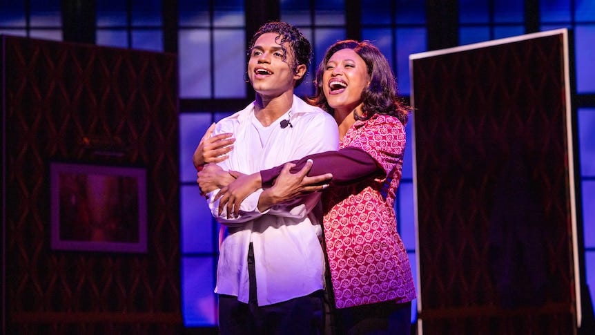 Actor Roman Banks dressed as Michael Jackson on stage singing with Josslynn Hlenti Afoa as Katherine