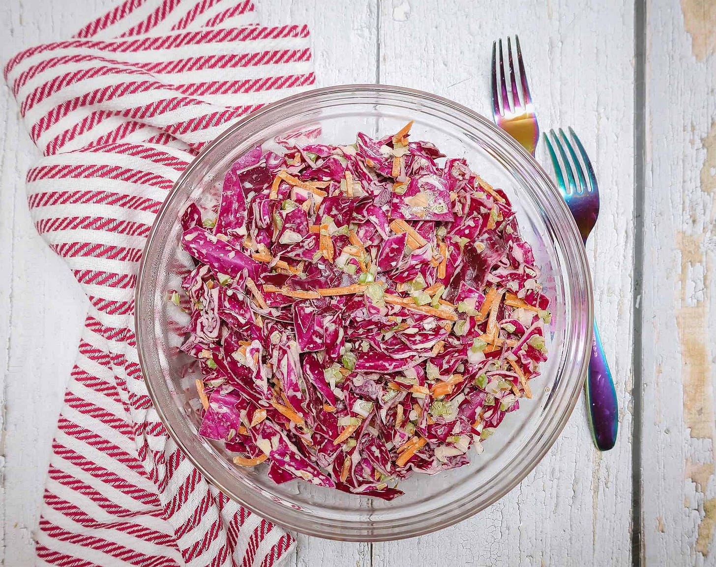 Juneteenth red slaw made with red cabbage, carrots, and soulful seasonings in a glass bowl, a colorful soul food side dish that honors the tradition of serving red foods on Juneteenth