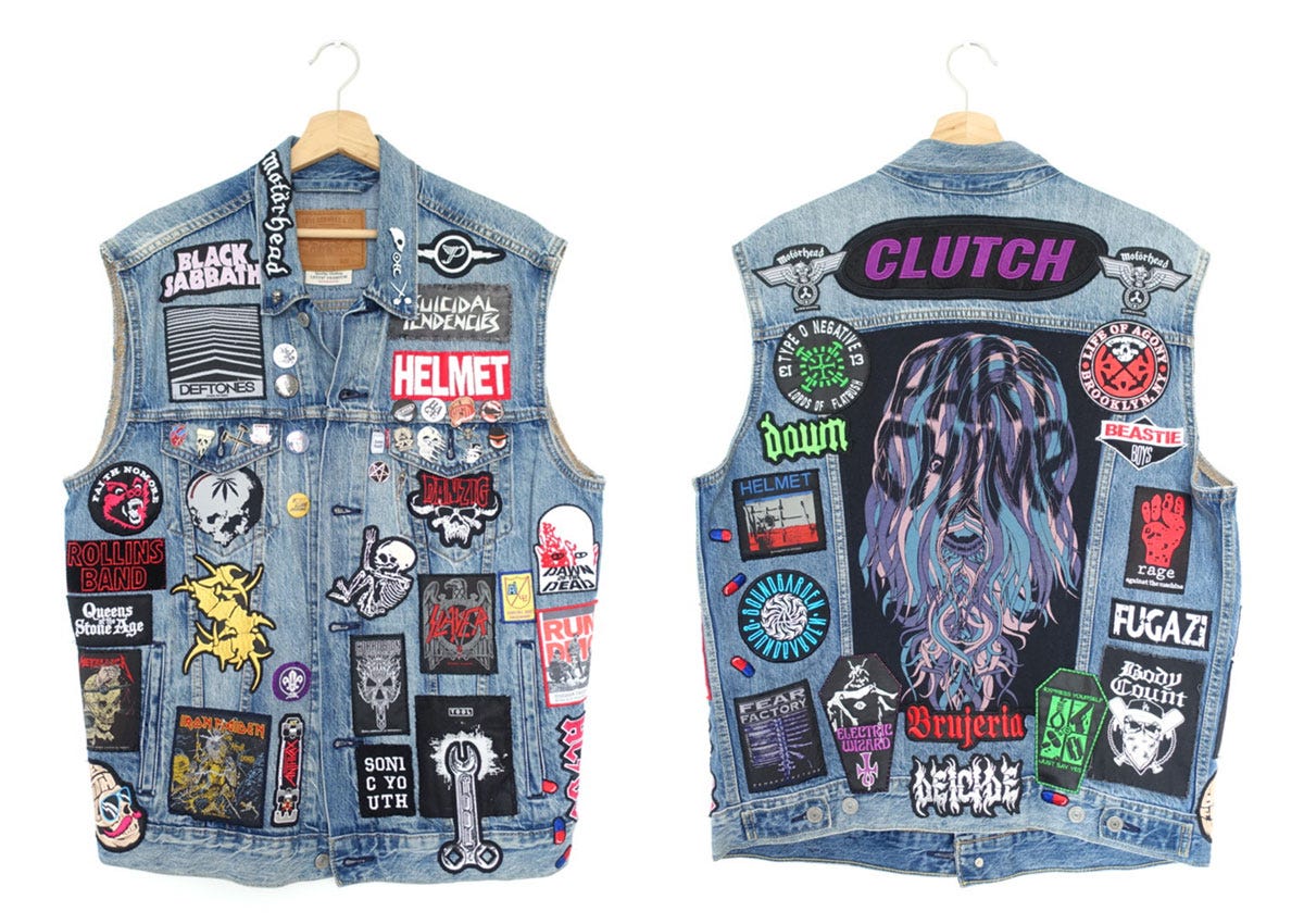 A composite image of the front and back of a sleeveless denim jacket decorated with embroidered patches and badges
