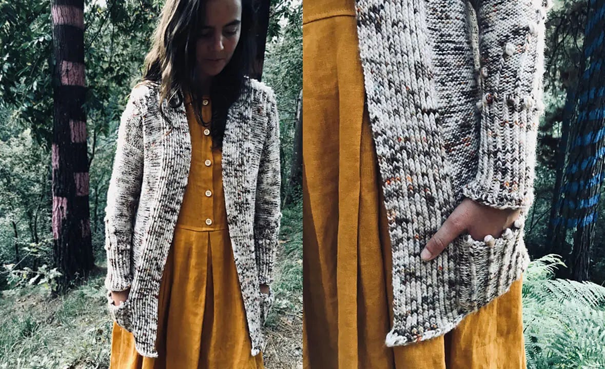 women with grey speckled cardigan over yellow dress walking in the woods