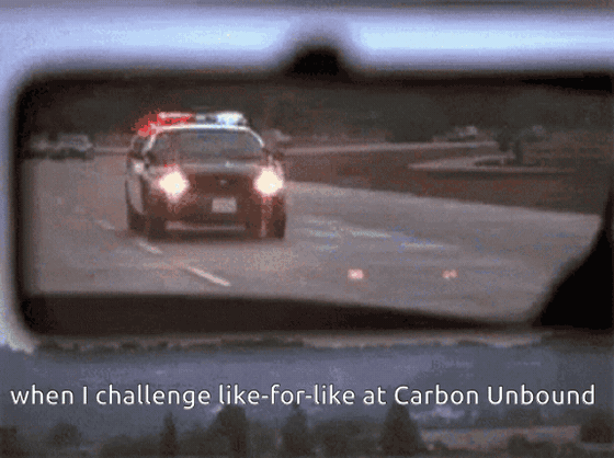 GIF of a police car with flashing lights seen in a rearview mirror. Text: "when I challenge like-for-like at Carbon Unbound"