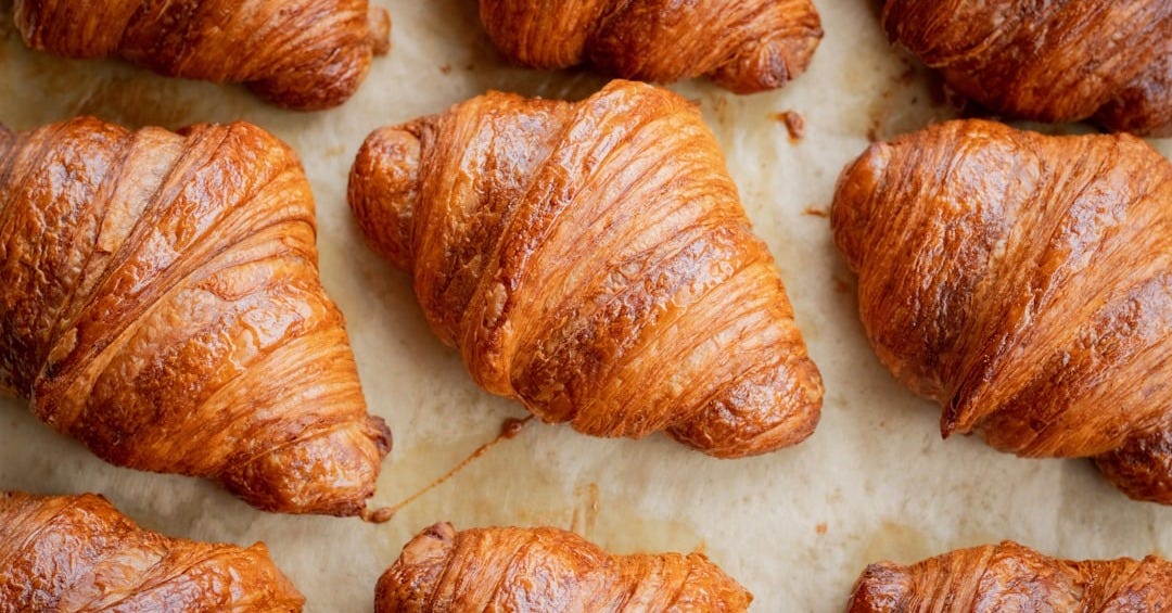 a bunch of croissants that are on a table a bunch of croissants that are on a table