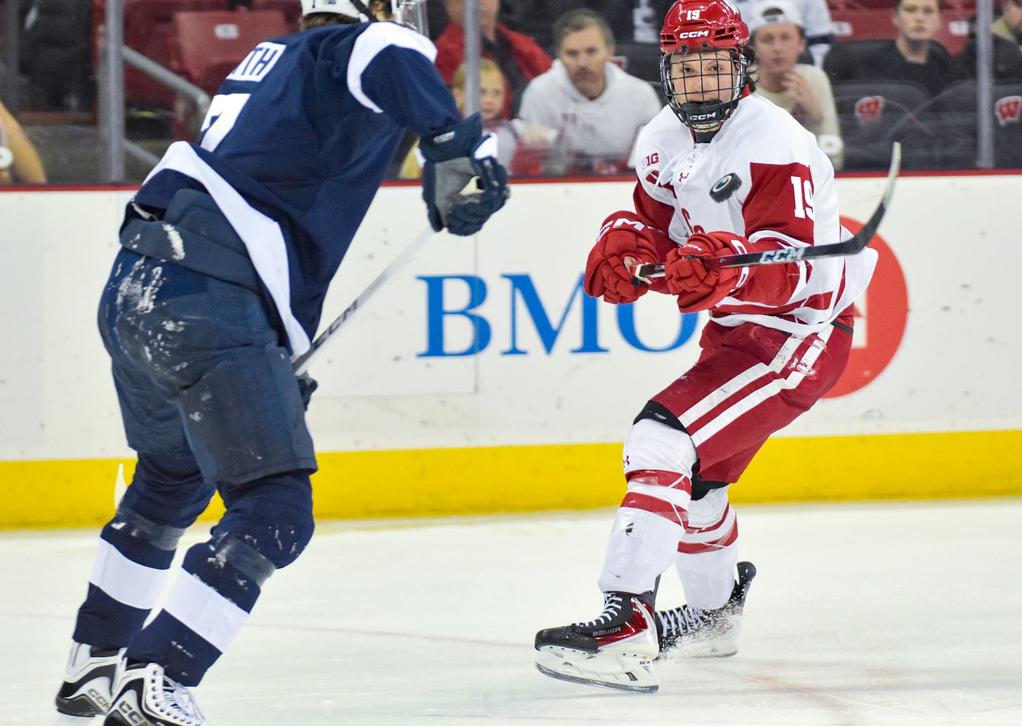 Quinn Finley holds his stick just above his waist as a puck bounces above it