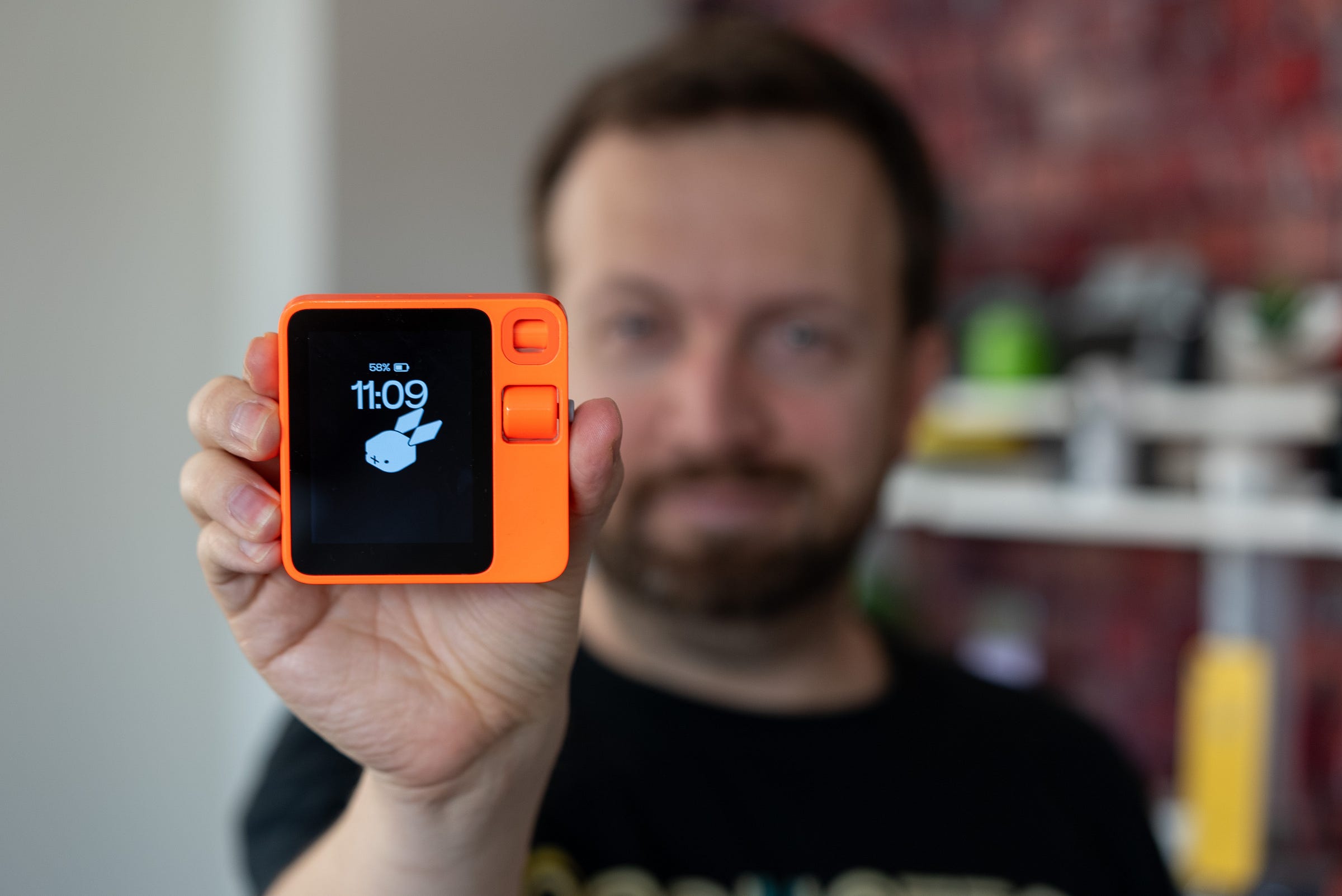 Rabbit R1 review with expert tech reviewer Matt Swider holding the AI device Rabbit R1 review with expert tech reviewer Matt Swider holding the AI device