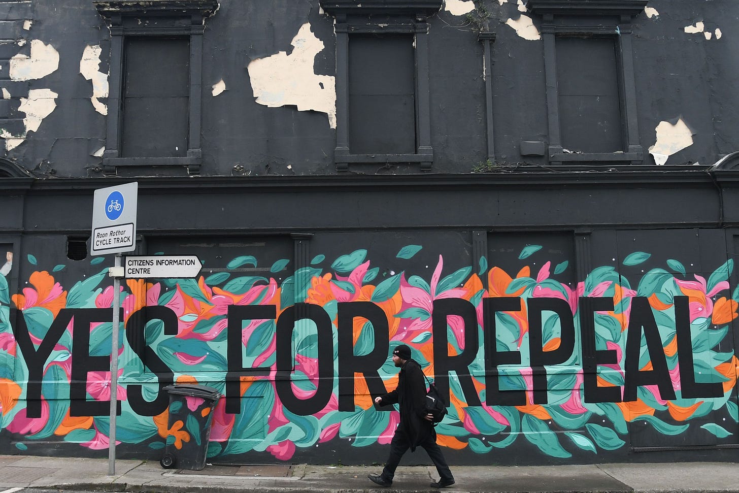A man walks in front of a pro-choice mural urging a yes vote in the referendum to repeal the eighth amendment of the Irish constitution, a subsection that effectively outlaws abortion in most cases, in Dun Laoghaire, Ireland, on May 10, 2018.(Photo by Artur Widak / AFP via Getty Images) A man walks in front of a pro-choice mural urging a yes vote in the referendum to repeal the eighth amendment of the Irish constitution, a subsection that effectively outlaws abortion in most cases, in Dun Laoghaire, Ireland, on May 10, 2018.(Photo by Artur Widak / AFP via Getty Images)